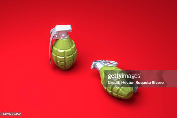 3d render of green hand grenade on red background,conflict and war concept - terrorism icon stock pictures, royalty-free photos & images