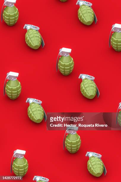 3d render of green hand grenade on red background,conflict and war concept - terrorism icon stock pictures, royalty-free photos & images