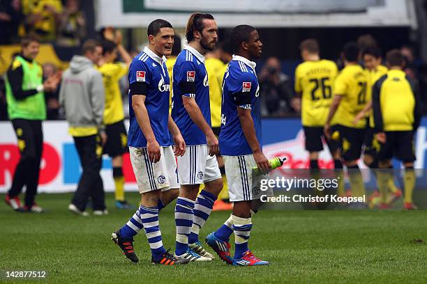 Kyriakos Papadopoulos, Christian Fuchs and Jefferson Farfan of Schalke look dejected after losing 1-2 the Bundesliga match between FC Schalke 04 and...