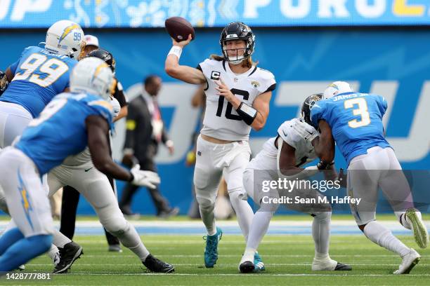 Trevor Lawrence of the Jacksonville Jaguars looks to pass during the first half of a game against the Los Angeles Chargers at SoFi Stadium on...