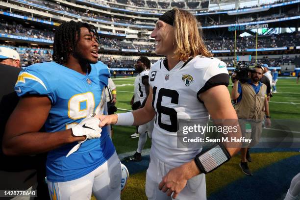 Chris Rumph II of the Los Angeles Chargers talks with Trevor Lawrence of the Jacksonville Jaguars after a game at SoFi Stadium on September 25, 2022...