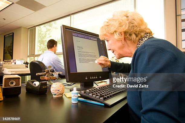 woman using liquid correction fluid on computer - correction fluid stockfoto's en -beelden
