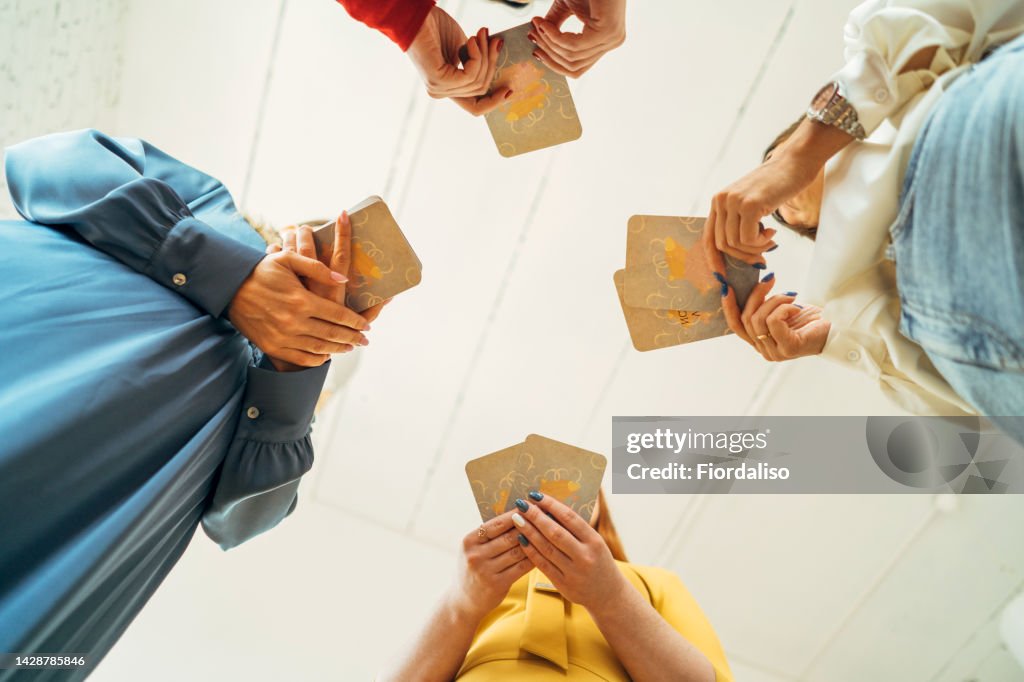 Four women are playing metaphorical card