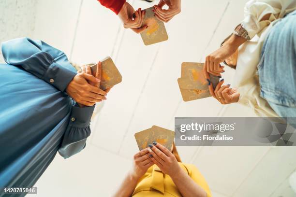 four women are playing metaphorical card - prophet stock pictures, royalty-free photos & images