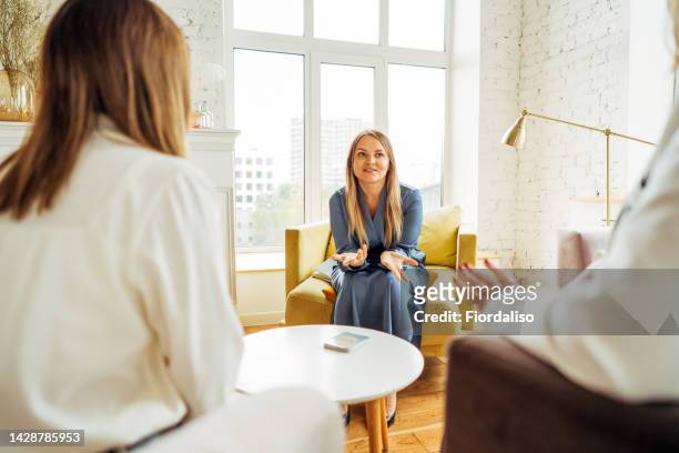 three women in armchairs are sitting and talking - fortune telling stock pictures, royalty-free photos & images