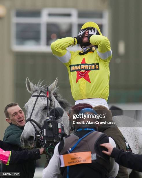 Daryl Jacob riding Neptune Collonges celebrates after winning The John Smith's Grand National at Aintree racecourse on April 14, 2012 in Liverpool,...