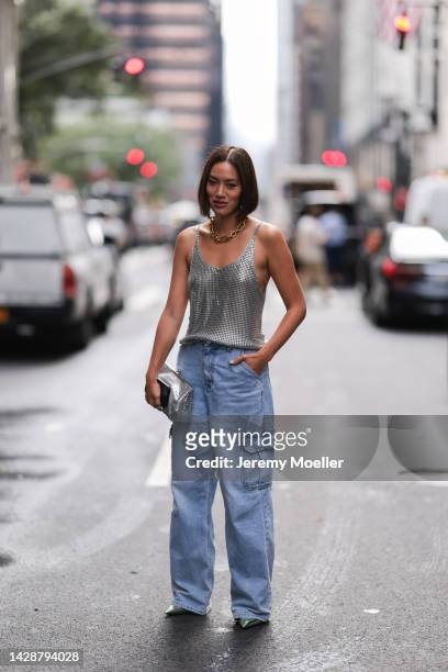 Tiffany Hsu seen wearing a silver top with jeans, outside Carolina Herrera during new york fashion week on September 12, 2022 in New York City.