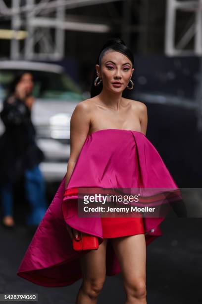 Jessica Wang seen wearing a short pink vokuhila dress, outside Carolina Herrera during new york fashion week on September 12, 2022 in New York City.