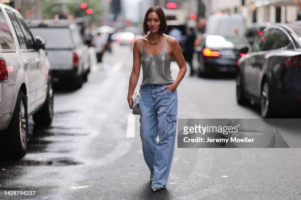Tiffany Hsu seen wearing a siler top with jeans, outside Carolina Herrera during new york fashion week on September 12, 2022 in New York City.
