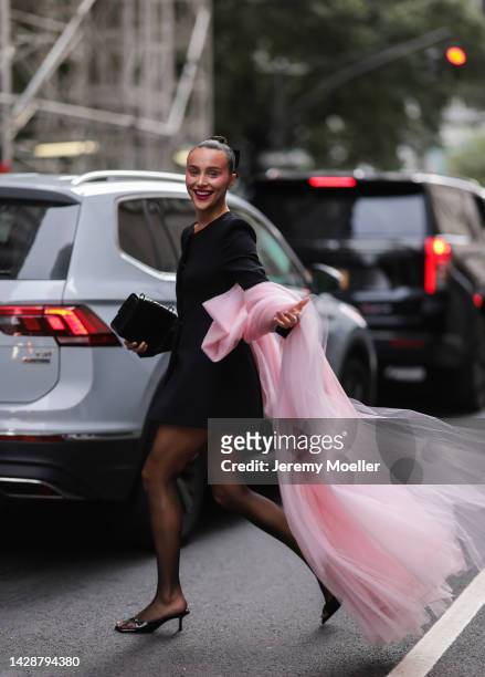 Mary Leest seen wearing a black dress with pink tulle, outside Carolina Herrera during new york fashion week on September 12, 2022 in New York City.