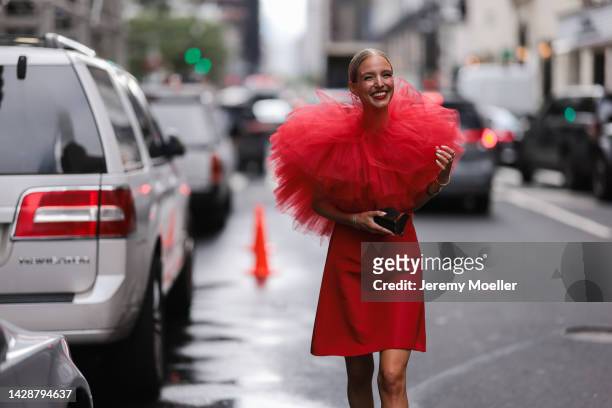 Leonie Hanne seen wearing a red dress with tulle, outside Carolina Herrera during new york fashion week on September 12, 2022 in New York City.