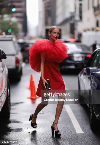 Leonie Hanne seen wearing a red dress with tulle, outside Carolina Herrera during new york fashion week on September 12, 2022 in New York City.