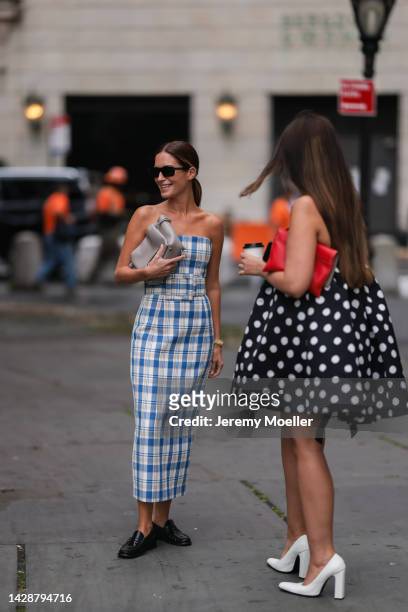 Gala González seen wearing a long blue and white patterned dress and Ola Farahat seen wearing a polka dot dress, outside Carolina Herrera during new...