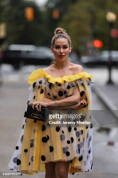 Fashion week guest seen wearing a yellow polka dot dress, outside Carolina Herrera during new york fashion week on September 12, 2022 in New York...