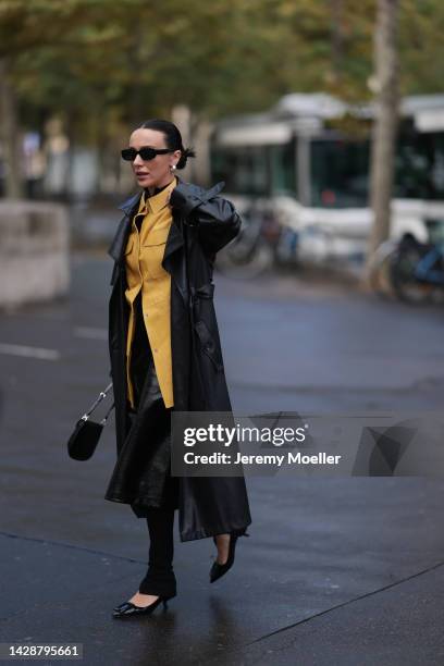 Mary Leest seen wearing a prada bag, a yellow leather blouse and a black leather skirt, outside Mame Kurogouchi during Paris Fashion Week on...