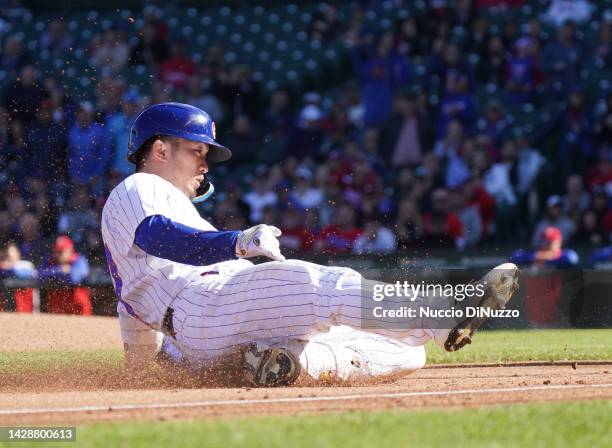 Seiya Suzuki of the Chicago Cubs slides into third base on his triple during the fifth inning of a game against the Philadelphia Phillies at Wrigley...