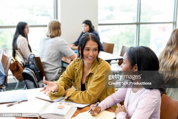 female university student tutors female high school student - professor particular imagens e fotografias de stock