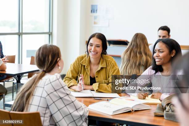 female friends smile while listening to unrecognizable female friend - female high school student 個照片及圖片檔