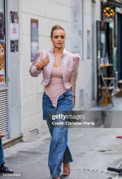 Olga Leffers wears rose cropped blazer, body, denim jeans outside Rochas during Paris Fashion Week - Womenswear Spring/Summer 2023 : Day Three on...