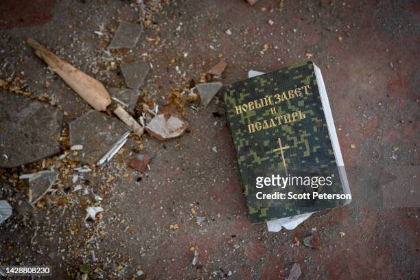 Russian Orthodox bible lies amid ruins of a Russian military field hospital that litter the Izium Middle School No. 2, which was used as a Russian...