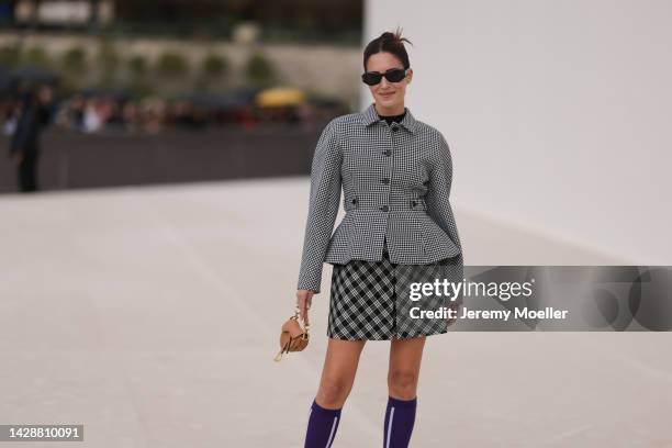 Gala Gonzalez seen wearing a blazer and patterned skirt by dior, shoes and sunglasses by dior, outside Christian Dior during Paris Fashion Week on...