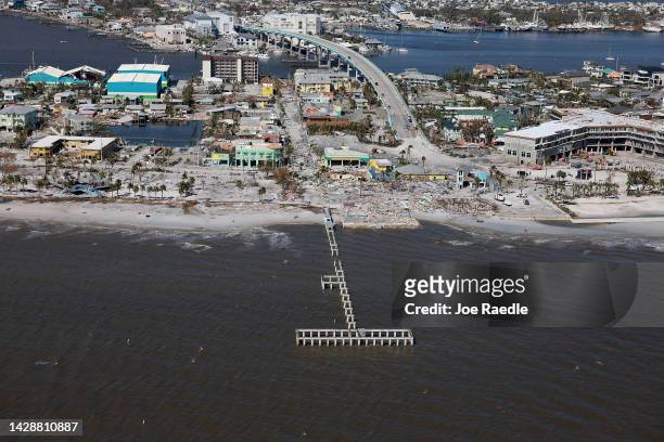 In an aerial view, a damaged Fort Myers Beach pier and surrounding buildings are seen after Hurricane Ian passed through the area on September 29,...