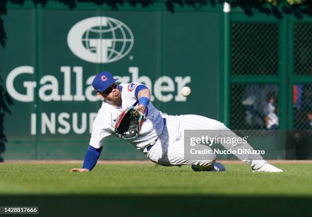 Ian Happ of the Chicago Cubs catches the fly out by J.T. Realmuto of the Philadelphia Phillies during the eighth inning of a game at Wrigley Field on...