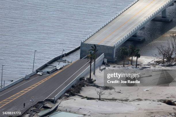 In this aerial view, the Sanibel Causeway bridge collapsed in places after Hurricane Ian passed through the area on September 29, 2022 in Sanibel,...