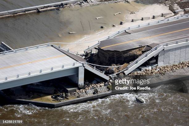 In this aerial view, the Sanibel Causeway bridge collapsed in places after Hurricane Ian passed through the area on September 29, 2022 in Sanibel,...