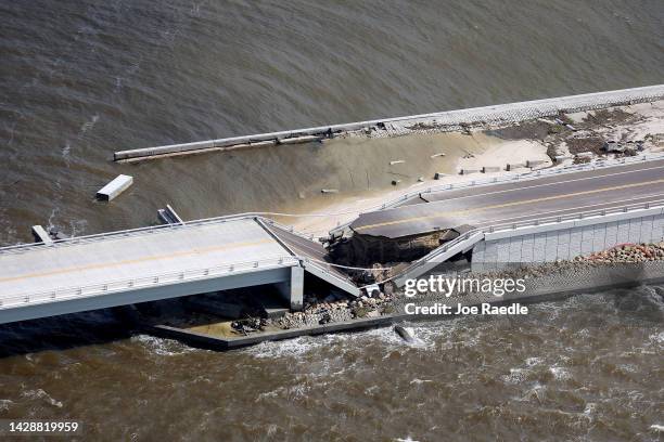 In this aerial view, the Sanibel Causeway bridge collapsed in places after Hurricane Ian passed through the area on September 29, 2022 in Sanibel,...