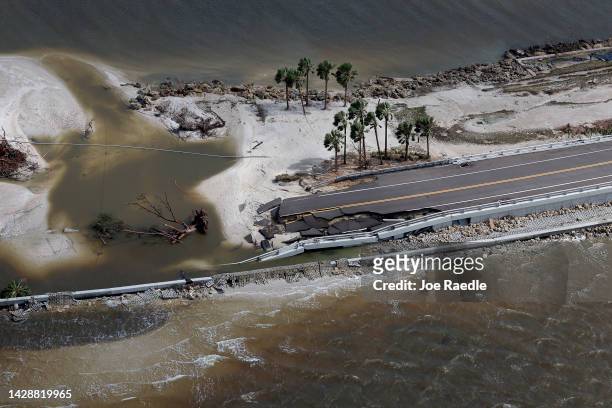 In this aerial view, parts of Sanibel Causeway are washed away along with sections of the bridge after Hurricane Ian passed through the area on...