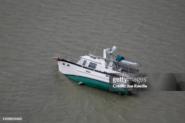 In this aerial view, a boat is capsized after Hurricane Ian passed through the area on September 29, 2022 in Sanibel, Florida. The hurricane brought...