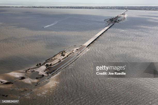 In this aerial view, parts of Sanibel Causeway are washed away along with sections of the bridge as Hurricane Ian passed through the area on...