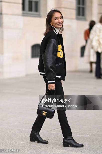 Maria Sivakova is seen wearing a varsity jacket, black pants, black gold buckle bag and black boots outside the Chloe show during Paris Fashion Week...