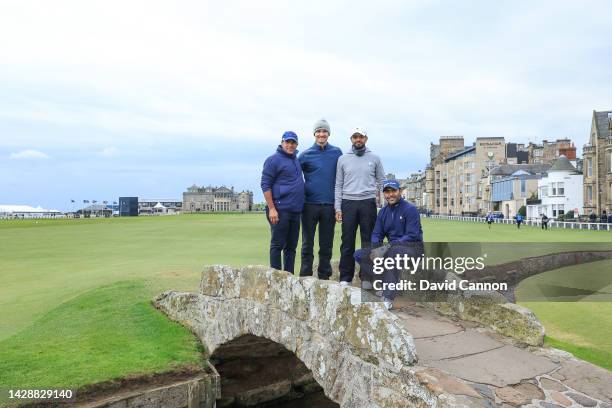 Rasmus Hojgaard of Denmark poses on The Swilcan Bridge for a photograph with his partner Mohammed Farooq of The uNited Arab Emirates and Abdullah Al...