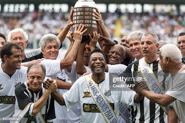 Former Brazilian footballer Edson Arantes do Nascimento, a.k.a. "Pele" , ambassador of the 2014 World Cup, ceelbrates with former team players during...