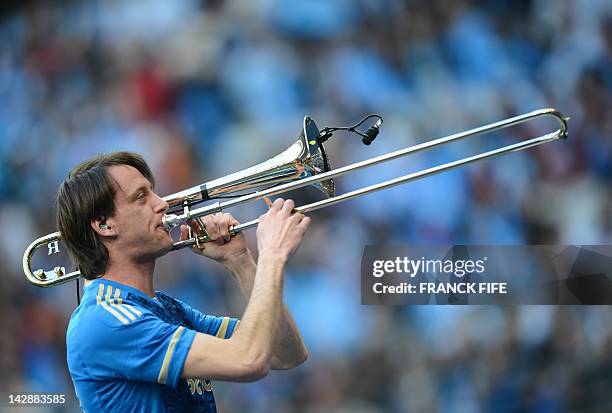 An Olympique de Marseille's musician plays trombone before the French League Cup Final football match Lyon vs. Marseille at the Stade de France in...