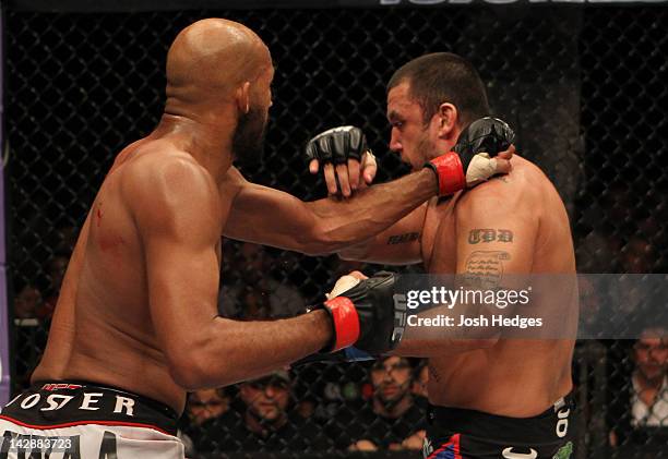 Cyrille Diabate punches Tom DeBlass during their light heavyweight bout at the UFC on Fuel TV event at Ericsson Globe on April 14, 2012 in Stockholm,...