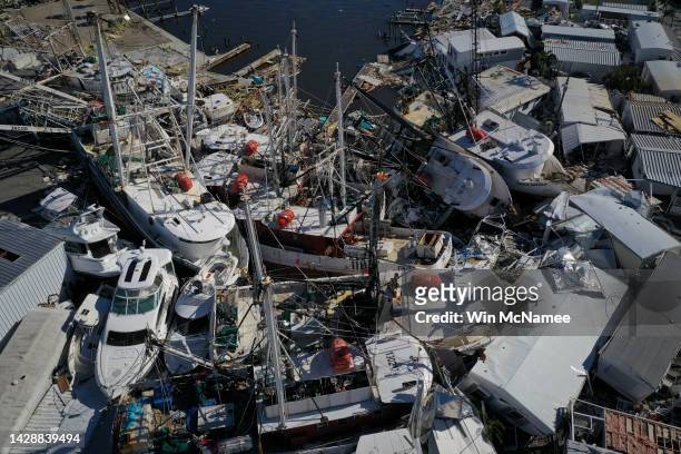 In this aerial view, boats sit atop one another in a marina near Fort Myers Beach on September 29, 2022 in San Carlos Island, Florida. Hurricane Ian...