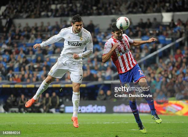 Cristiano Ronaldo of Real Madrid CF beats Alberto Botia to score their second goal during the La Liga match between Real Madrid CF and Real Sporting...