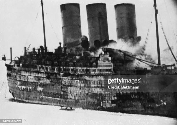 View of the S.S. Empress of Britain as it burns after being bombed by German submarines in the North Atlantic. The ship sank to the bottom of the...