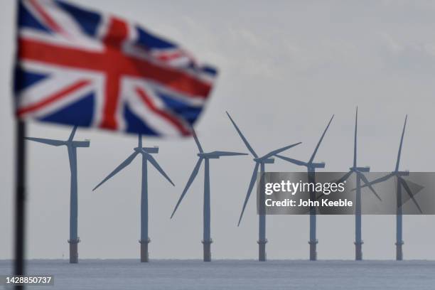 Gunfleet Sands offshore wind farm turbines can be seen as a Union Jack flag flies on September 29, 2022 in Clacton-On-Sea, England. At the recent...