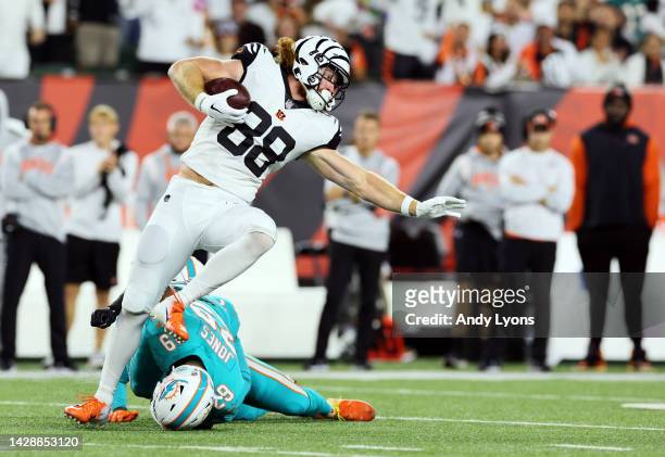 Tight end Hayden Hurst of the Cincinnati Bengals is tackled by safety Brandon Jones of the Miami Dolphins after making a catch during the 1st quarter...