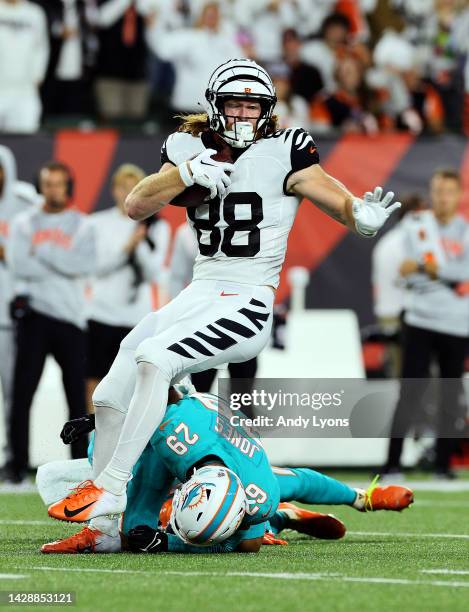 Tight end Hayden Hurst of the Cincinnati Bengals is tackled by safety Brandon Jones of the Miami Dolphins after making a catch during the 1st quarter...