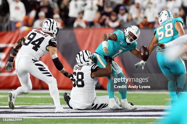 Quarterback Tua Tagovailoa of the Miami Dolphins is sacked by defensive tackle Josh Tupou of the Cincinnati Bengals during the 2nd quarter of the...
