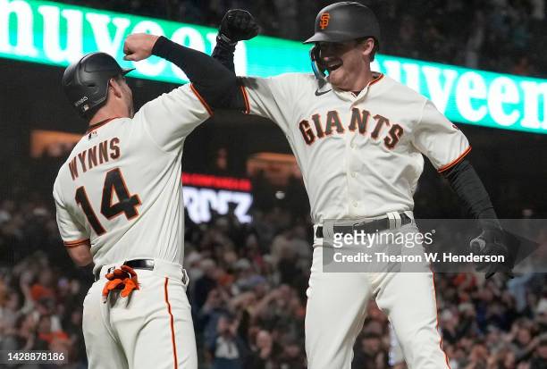Ford Proctor and Austin Wynns of the San Francisco Giants celebrates after Proctor hit a grand slam home run against the Colorado Rockies in the...