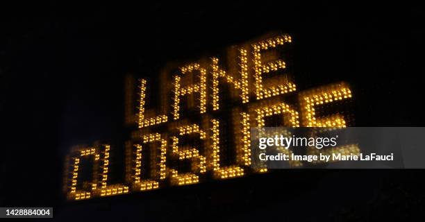 illuminated "lane closure" sign at night - print finishing stock pictures, royalty-free photos & images