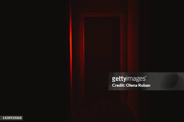 door illuminated with red lighting. - scary - fotografias e filmes do acervo