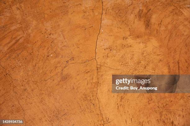 full frame shot of an earthen wall texture of clay house structure. - red sand stock pictures, royalty-free photos & images