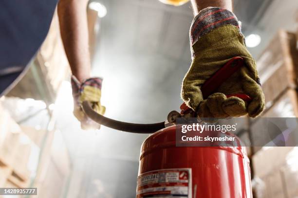 close up of using fire extinguisher in a warehouse. - extinguishing 個照片及圖片檔